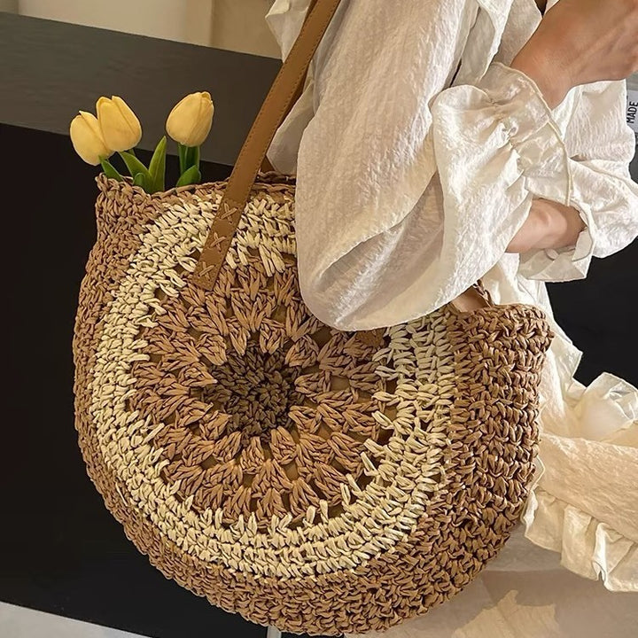 Casual tote bag with colorful straw weaving, perfect for beach outings, featuring a round design and stylish handle.