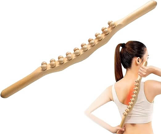 Woman using a wooden massage stick on her back with a white background