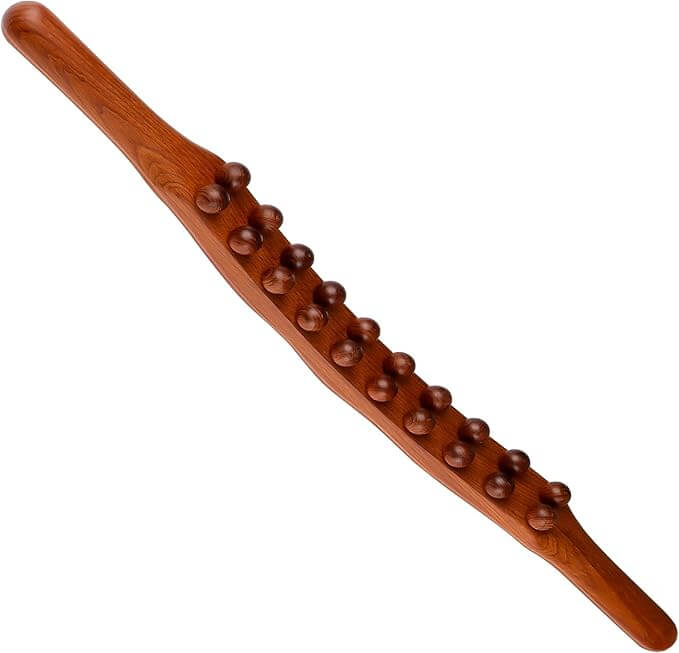Wooden massage stick with raised wooden massage beads on a white background