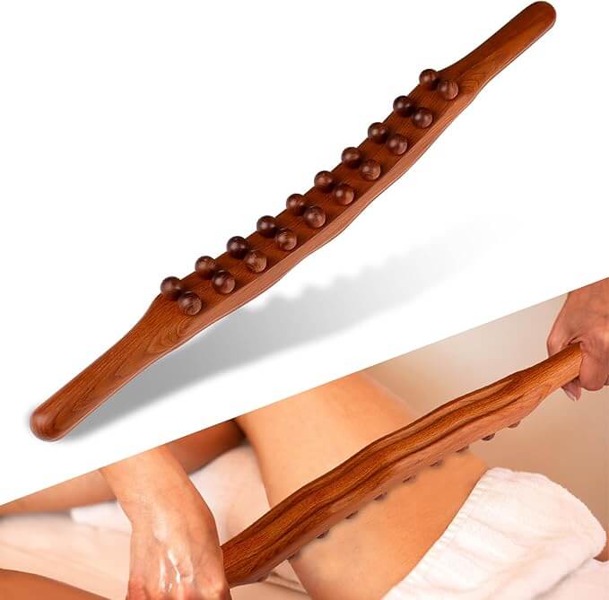 Wooden massage stick with massage beads on a white background