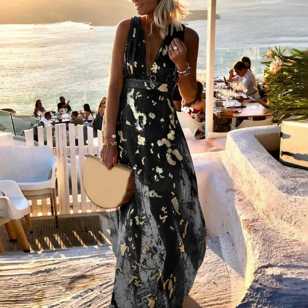 Woman in a black party beach dress standing on a sunlit outdoor patio with people in the background.