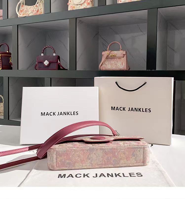 Pink handbag with floral pattern on a white surface, with 'Mack Jankles' branding.