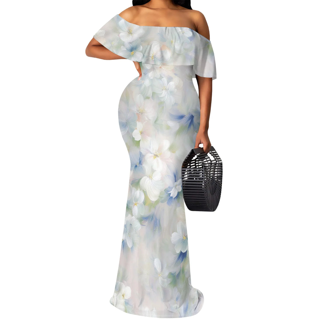Woman wearing a light blue floral off-shoulder dress holding a black handbag on a white background