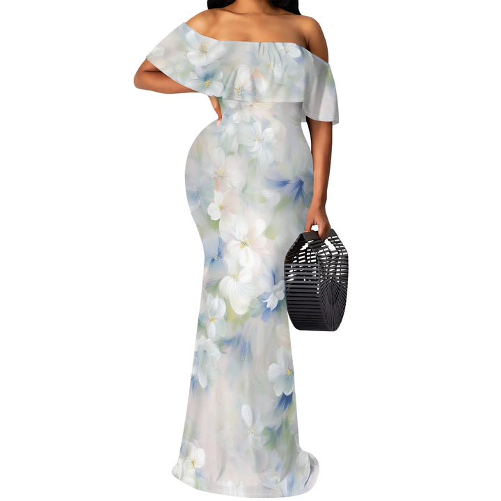 Woman wearing a light blue floral off-shoulder dress holding a black handbag on a white background