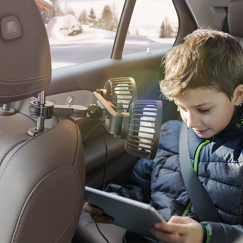 Boy using a tablet in a car with an adjustable backseat fan providing comfort.