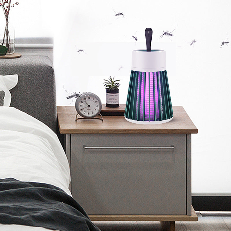 Electric mosquito killer lamp on bedside table, effectively eliminating mosquitoes in a cozy bedroom setting.