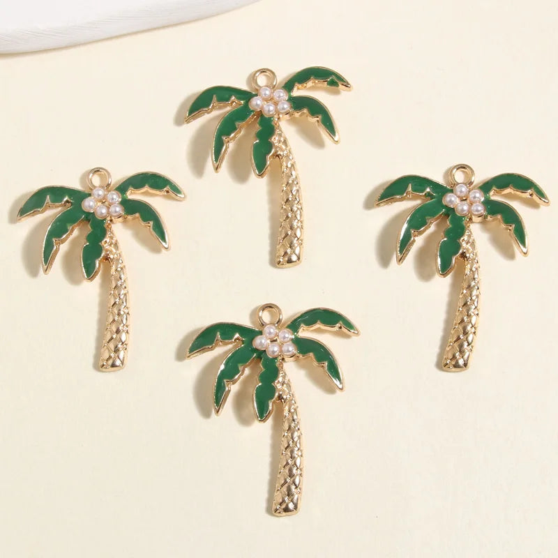 Gold coconut palm tree charms with green leaves and pearl accents, perfect for jewelry making supplies.