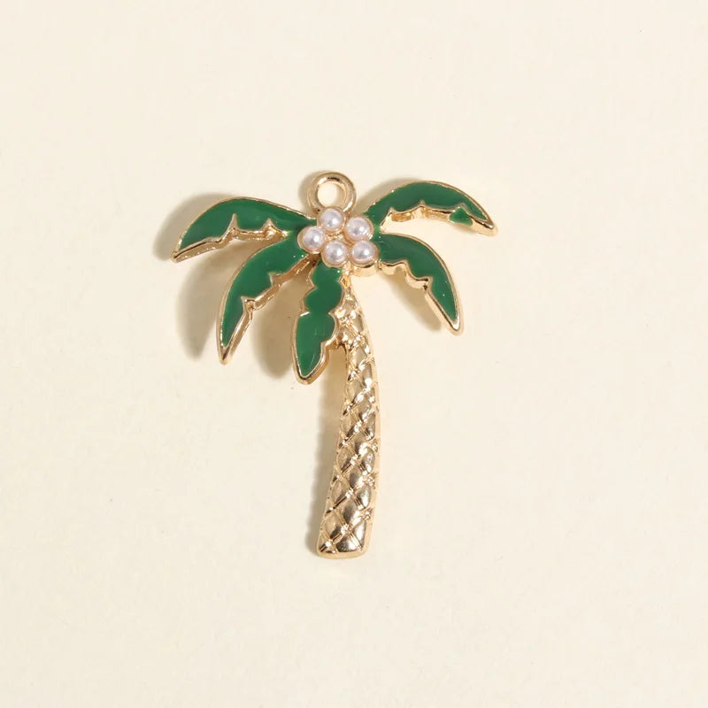 Gold coconut palm tree charm with green leaves and pearl details for jewelry making