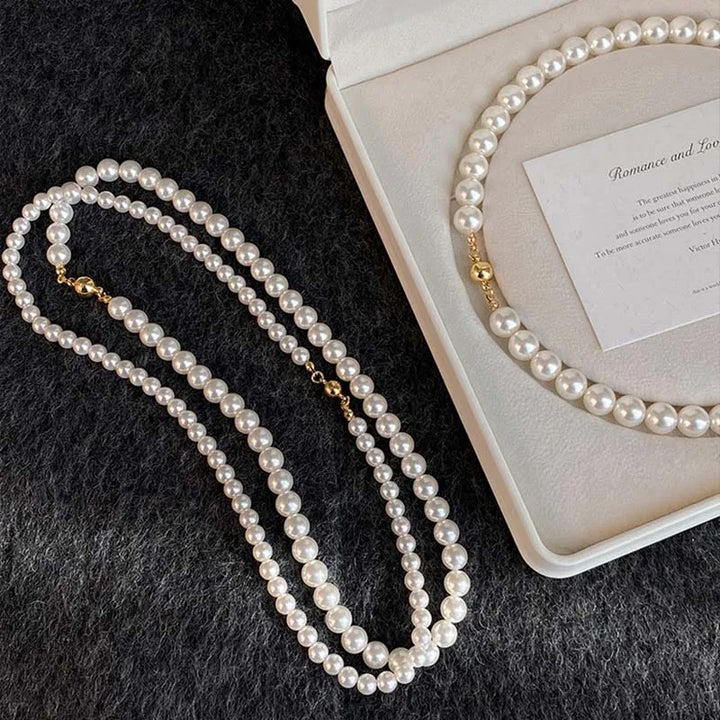 Elegant white pearl necklace displayed in a jewelry box, showcasing a luxurious and stylish design.