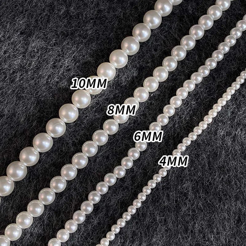 Different sizes of white pearl strands labeled 4MM, 6MM, 8MM, and 10MM on a textured background.