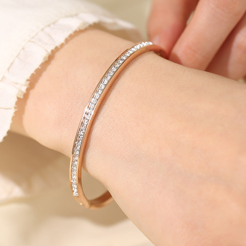 Elegant women's titanium bracelet with sparkly embellishments on a wrist, showcasing its stylish design.