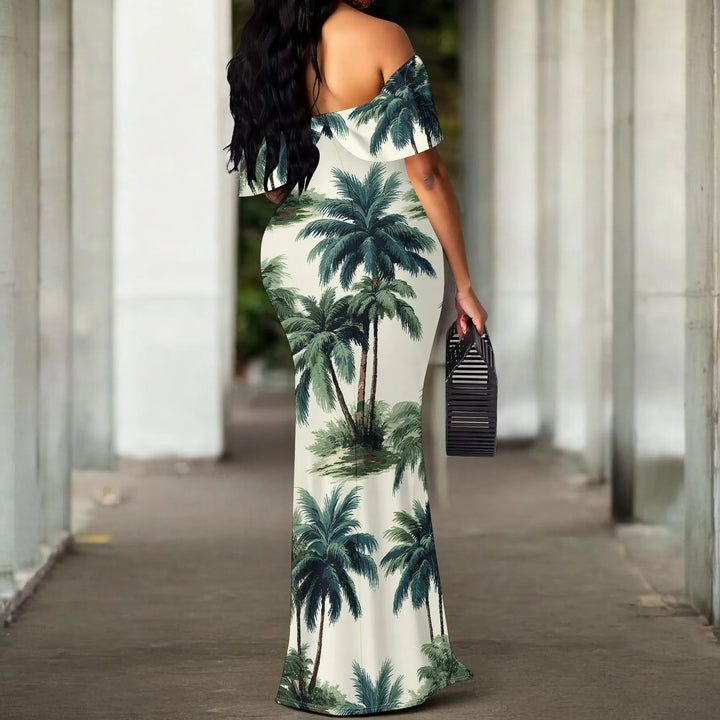A woman wearing a palm tree off-shoulder dress walking outdoors.