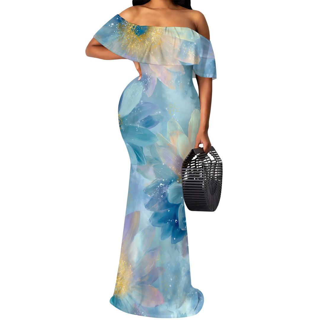 Woman wearing a blue floral off-shoulder dress holding a black handbag on a white background